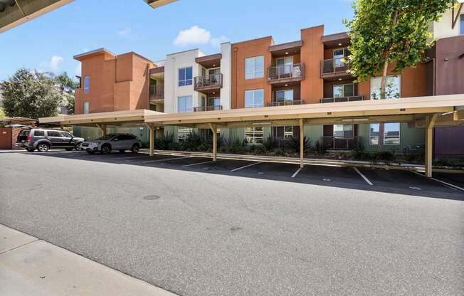 an empty parking lot in front of an apartment building