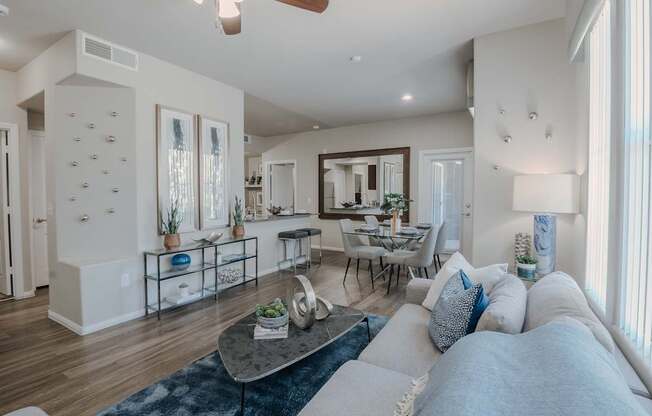 A modern living room with a grey sofa and a coffee table.