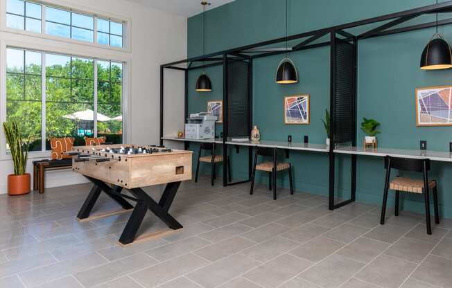 a games room with a foosball table and a bar