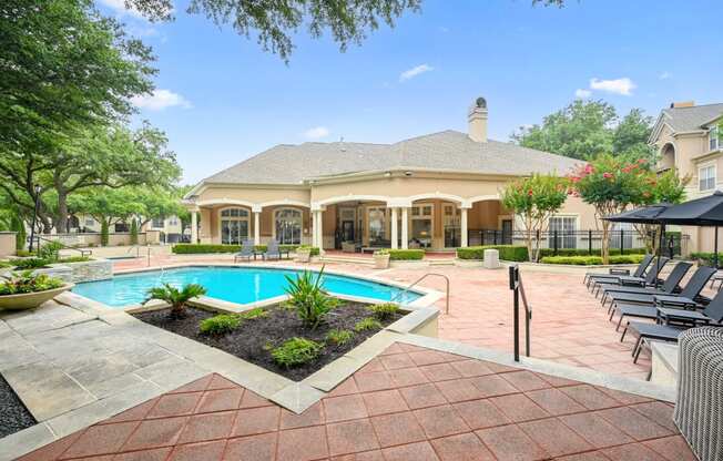 a house with a swimming pool and a patio with chairs