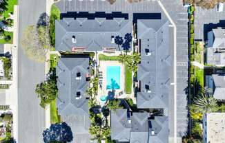 a birdseye view of a house with a pool in the middle of it
