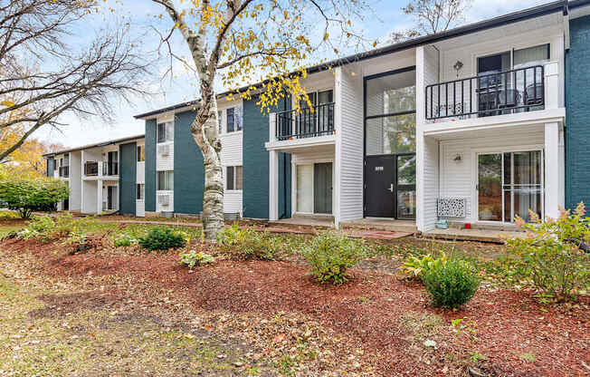 A row of modern townhouses with white and green exteriors.