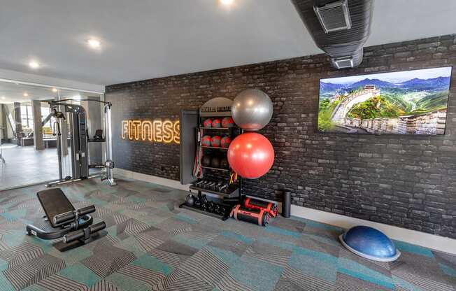 a gym with a brick wall and a large ballon on the wall