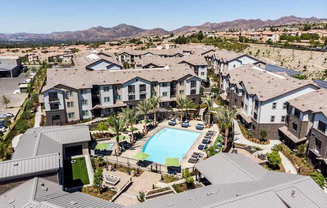 an aerial view of a resort style community with a large swimming pool