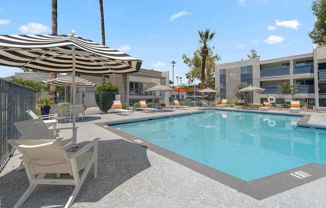 Umbrella table with chairs and grilling station at The Halifax apartments in Phoenix, AZ.