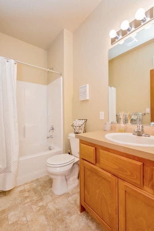 a bathroom with a toilet sink and shower