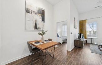 A dining room with a wooden table and chairs.