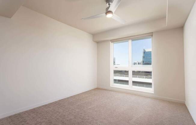 A room with a window and a ceiling fan. at Elements Apartments*, Irvine, CA