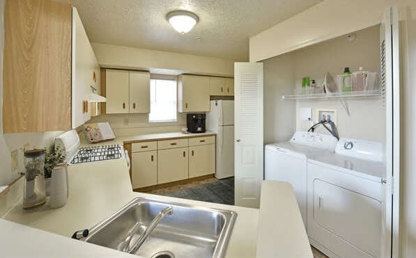 a kitchen with a sink and a washing machine