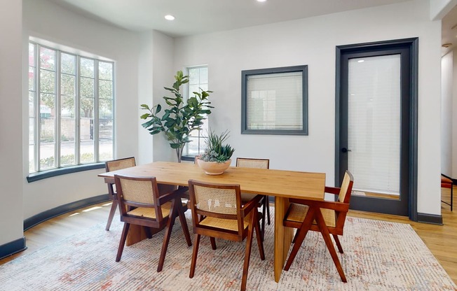 a dining room with a wooden table and chairs