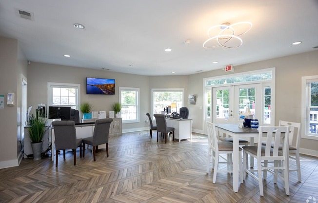 A spacious room with a dining table and chairs.