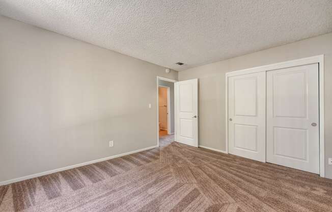 Bedroom 1 with large closets and wall to wall carpet
