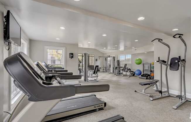 a gym with treadmills and other exercise equipment at the enclave at woodbury