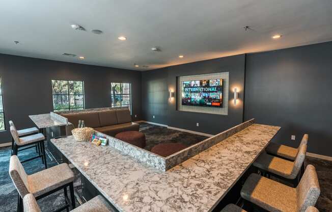 theater room with couches and bar seating