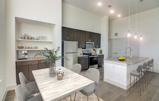 an open kitchen and dining room with a table and chairs