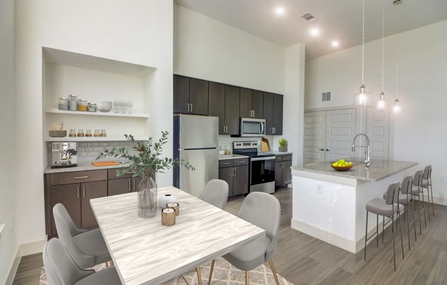 an open kitchen and dining room with a table and chairs