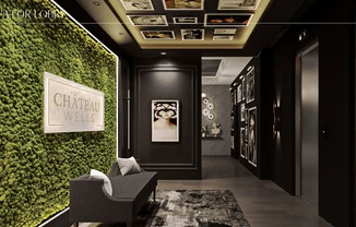 a living wall with green plants and a chair in a lobby at Chateau on Wells, Chicago, 60654