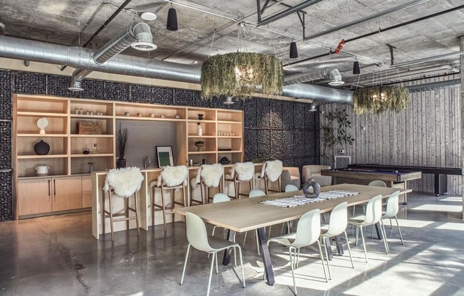 A conference room with a long table and chairs.
