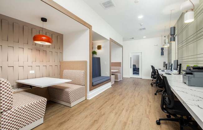 A modern office space with a wooden floor and a white table.
