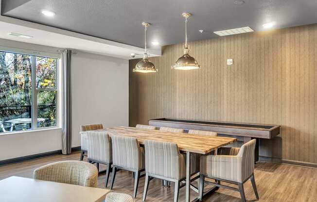 A conference room with a long table and chairs.