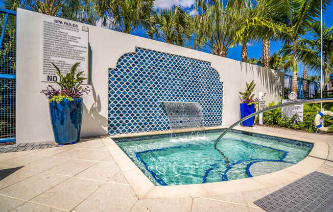 small pool surrounded by blue mosaic tiles on wall at Magnolia Square, Naples, Florida