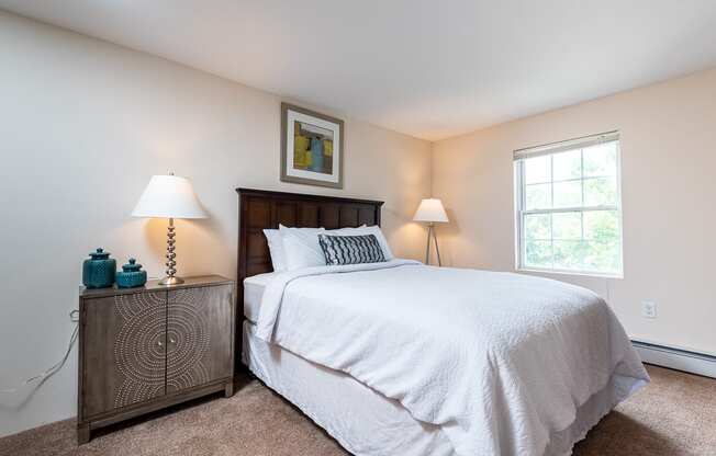 Two bedroom with large windows and plush carpet