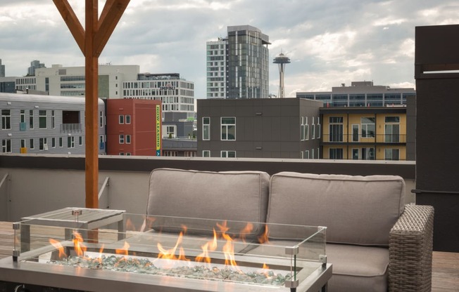 Luxury Apartments for Rent in Seattle, WA - Union Bay - Firepit Area with Raised Firepit, City View, and Patio Furniture