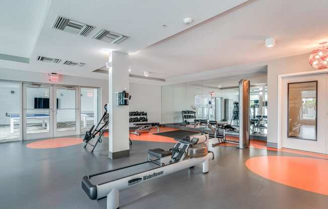 a workout room with weights and other exercise equipment at theova apartments