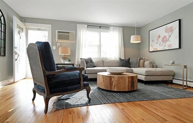 Living area featuring section sofa, round coffee table, and accent chair at Alister Morristown, Morristown, NJ, 07960