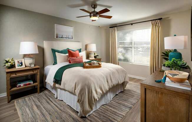 Seacrest Bedroom Large Windows Allow in Plentiful Natural Light Featuring 2 Faux Wood Blinds