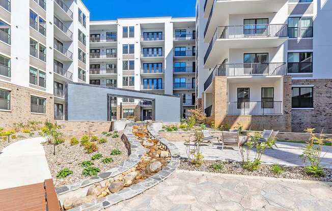 Zen garden courtyard with babbling brook and firepit