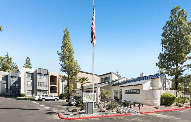 A building with a sign that says "LEASING" in front of it.