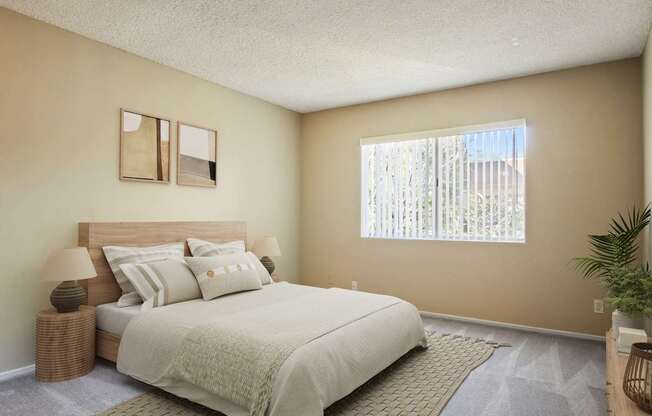 A bedroom with a large bed and a window with blinds.