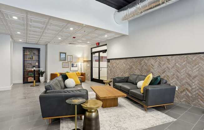 A living room with a grey couch and a wooden coffee table.