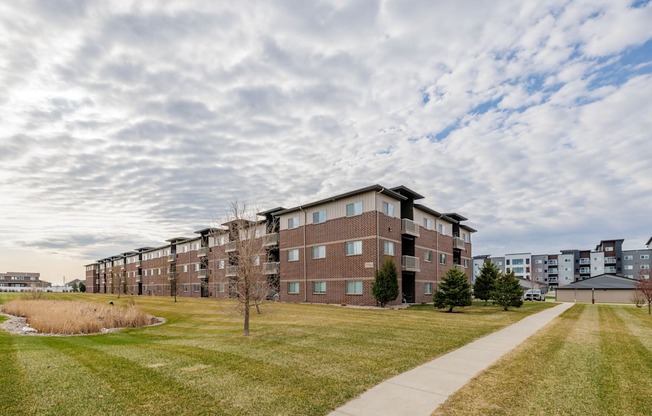 A long building with a walkway in front of it.