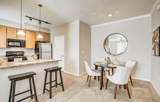 an open kitchen and dining area with a dining table and chairs at Adiamo Palm Valley, Goodyear, Arizona
