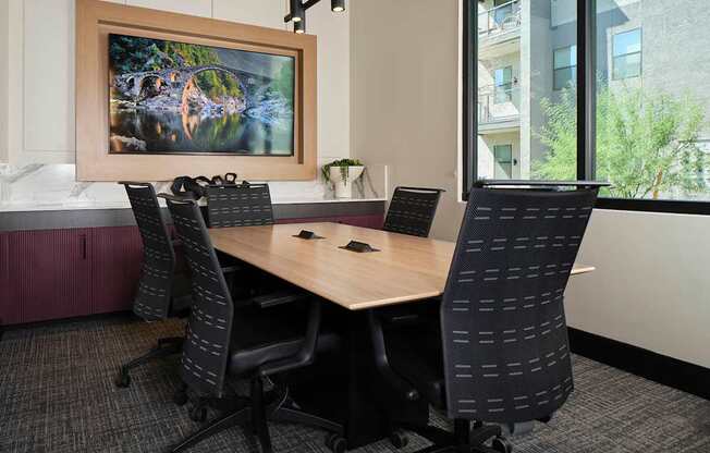 a conference room with a wooden table and chairs
