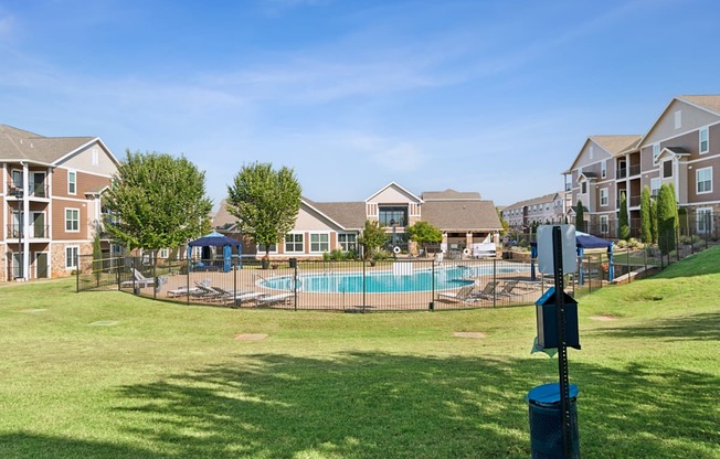 A sunny day at a residential complex with a swimming pool.