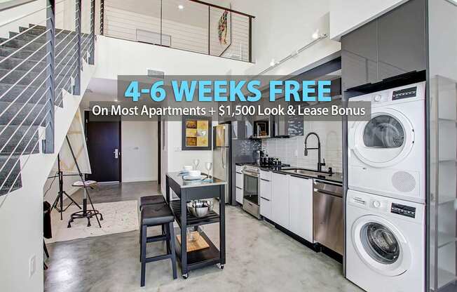A modern kitchen with a washing machine and a dining table.