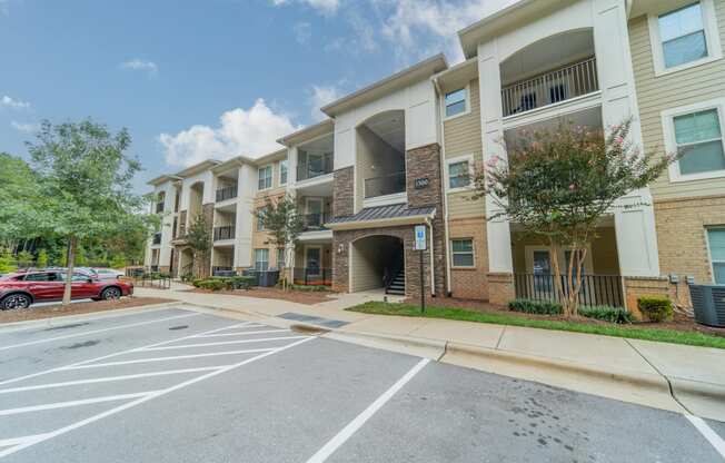 an apartment building with a parking lot and a street