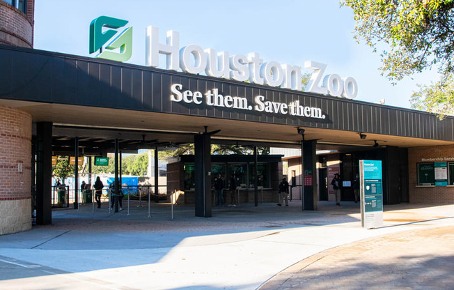 the entrance to the zoo with a sign on the building