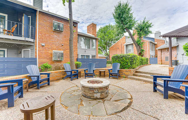 A courtyard with a fire pit and seating area.