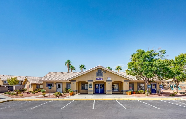 Apartments for Rent in Las Vegas NV-Portola Del Sol Apartments Exterior Of Complex With Front Parking Spaces And Trees
