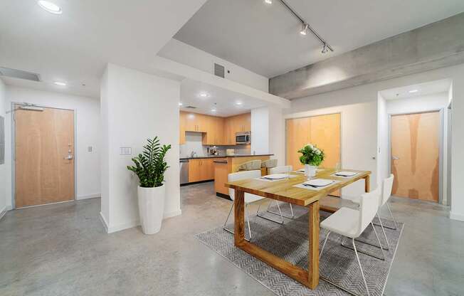 A modern kitchen with a dining table and chairs.