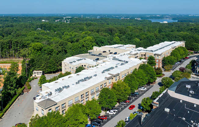 A large white building with a parking lot in front of it.