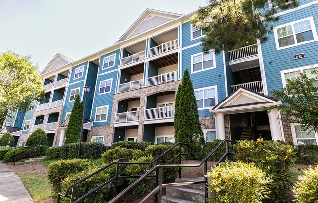 an apartment building with stairs in front of it