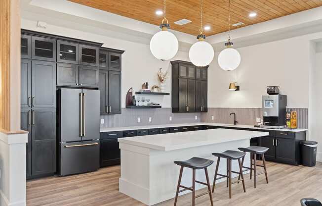 Kitchen with a large white island and black cabinetsat Hadley Place Apartments, Pennsylvania