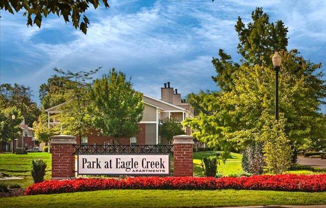 Outdoor signage for community entrance reads park at eagle creek