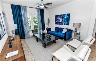 a living room with a blue couch and a black coffee table