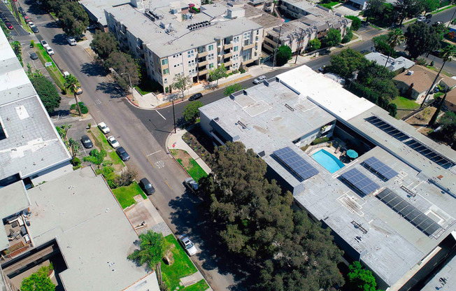 Aerial drone image of Rose Apartments and courtyard with pool.